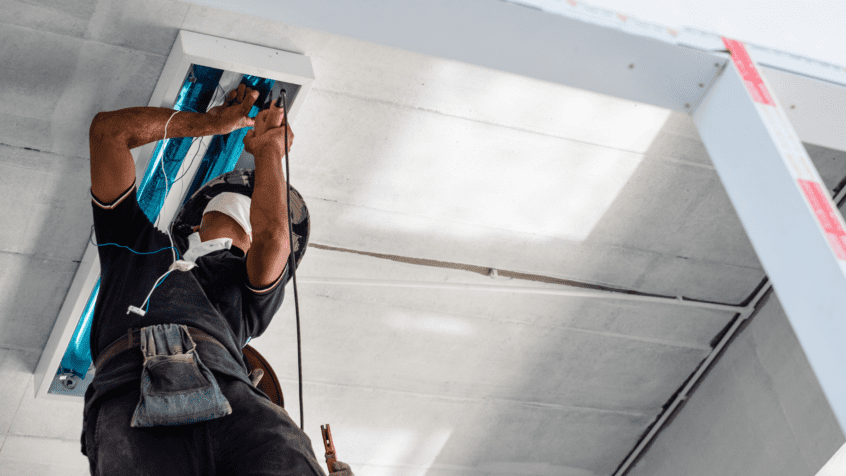 visual image of electrician working on office lights