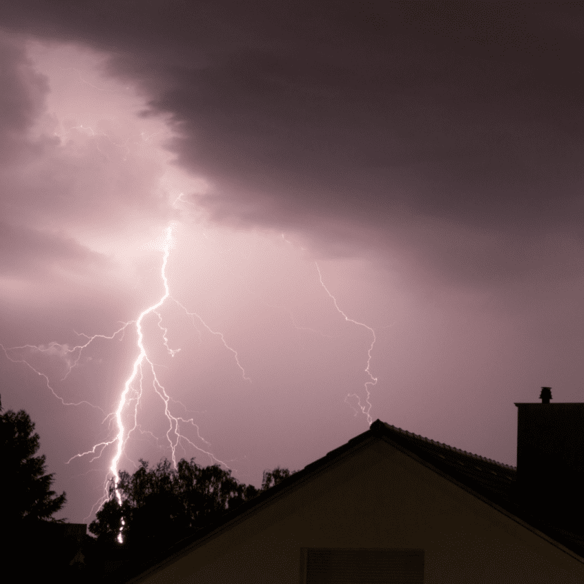 Image of lightening striking behind a house