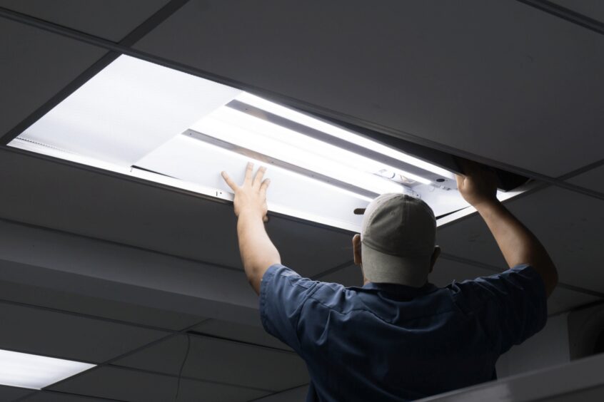 Image of electrician fixing an overhead light